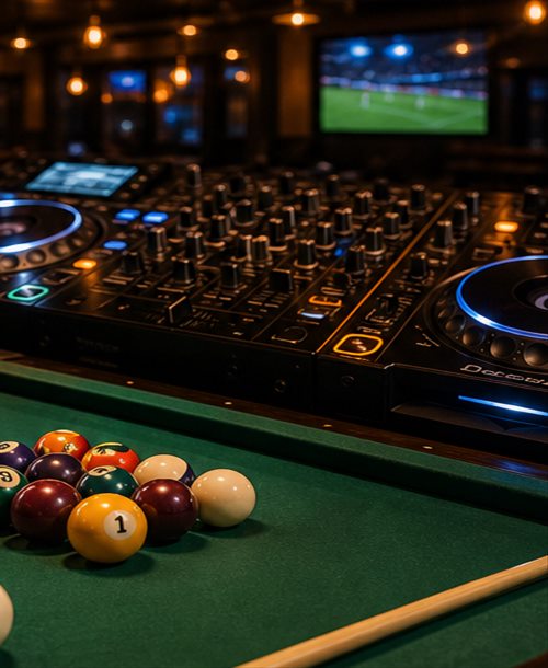 Pool table with balls and DJ mixer in a warm lounge