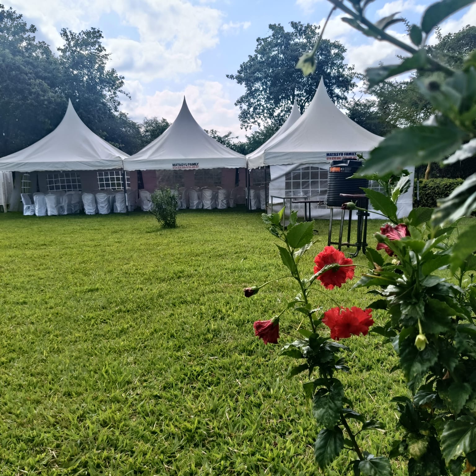 White event tents set up on a green garden lawn at Lemara Gardens Wamunyu
